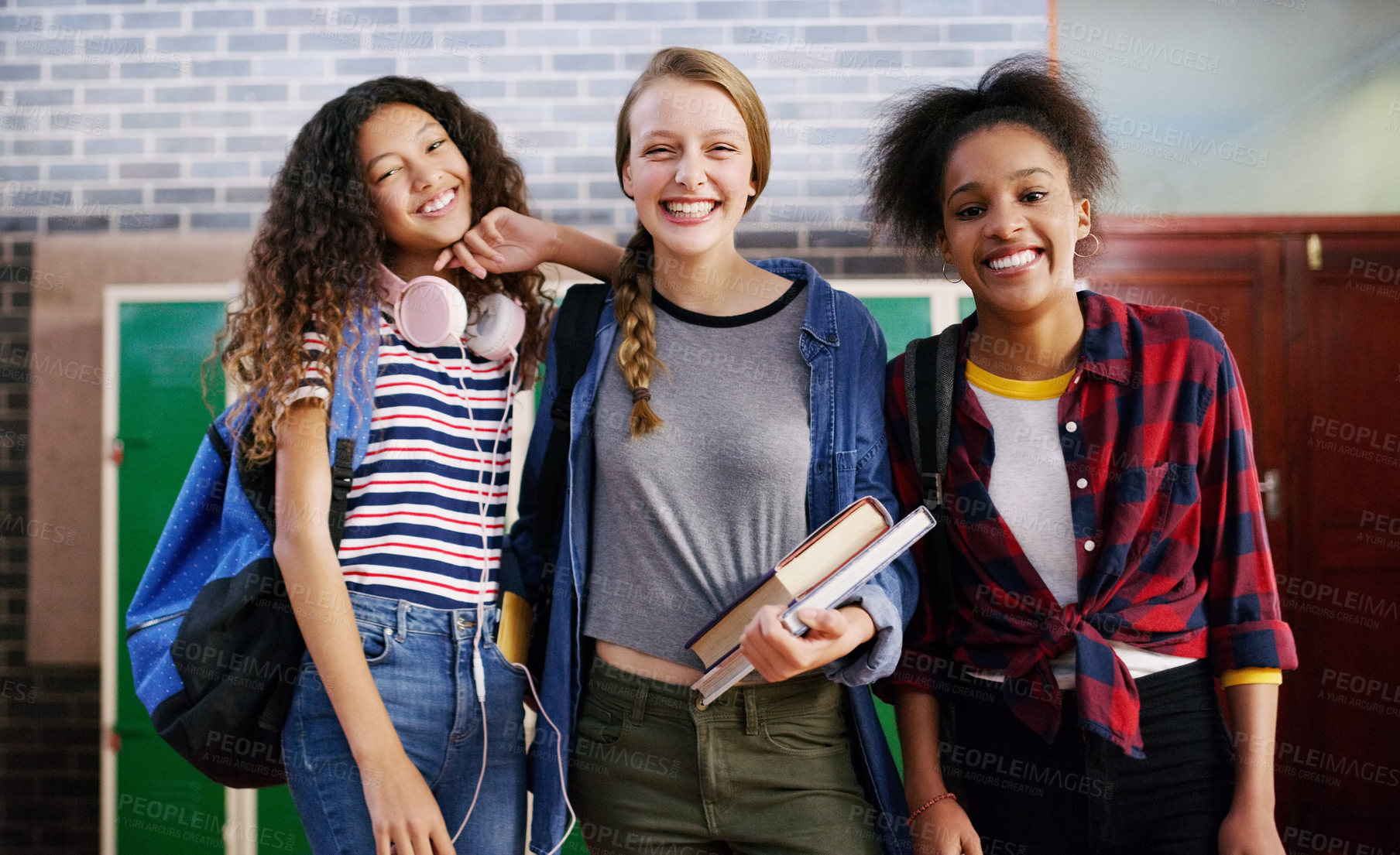 Buy stock photo Portrait of a group of young school kids standing together smiling brightly while waiting to go to class inside of a school during the day