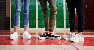 Buy stock photo Low angle shot of a group of unrecognizable student's shoes with them standing and waiting to go to class
