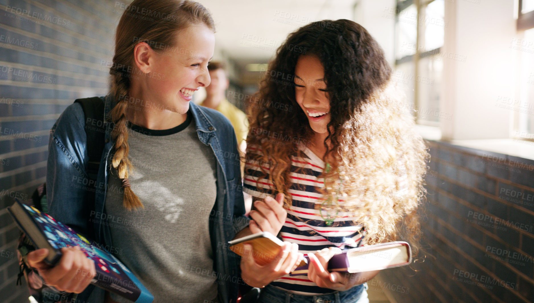 Buy stock photo Cropped shot of two cheerful young school kids walking to class together inside of a school during the day