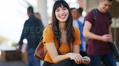 Buy stock photo Portrait of a cheerful young student browsing on her digital tablet while waiting to go to class outside of a school during the day