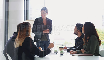 Buy stock photo Shot of a young businesswoman giving a presentation to her colleagues in an office