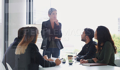 Buy stock photo Shot of a young businesswoman giving a presentation to her colleagues in an office