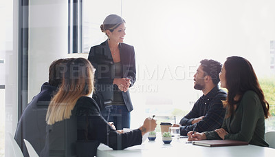 Buy stock photo Shot of a young businesswoman giving a presentation to her colleagues in an office