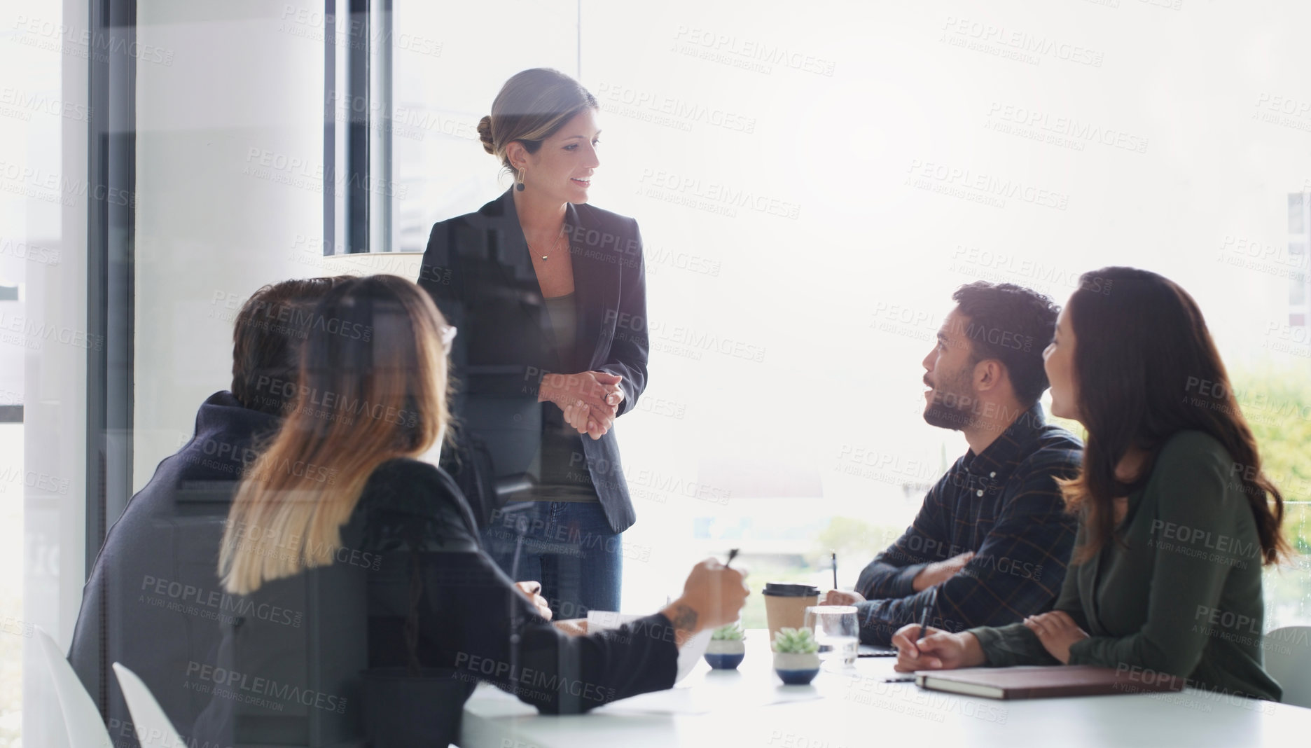 Buy stock photo Shot of a young businesswoman giving a presentation to her colleagues in an office