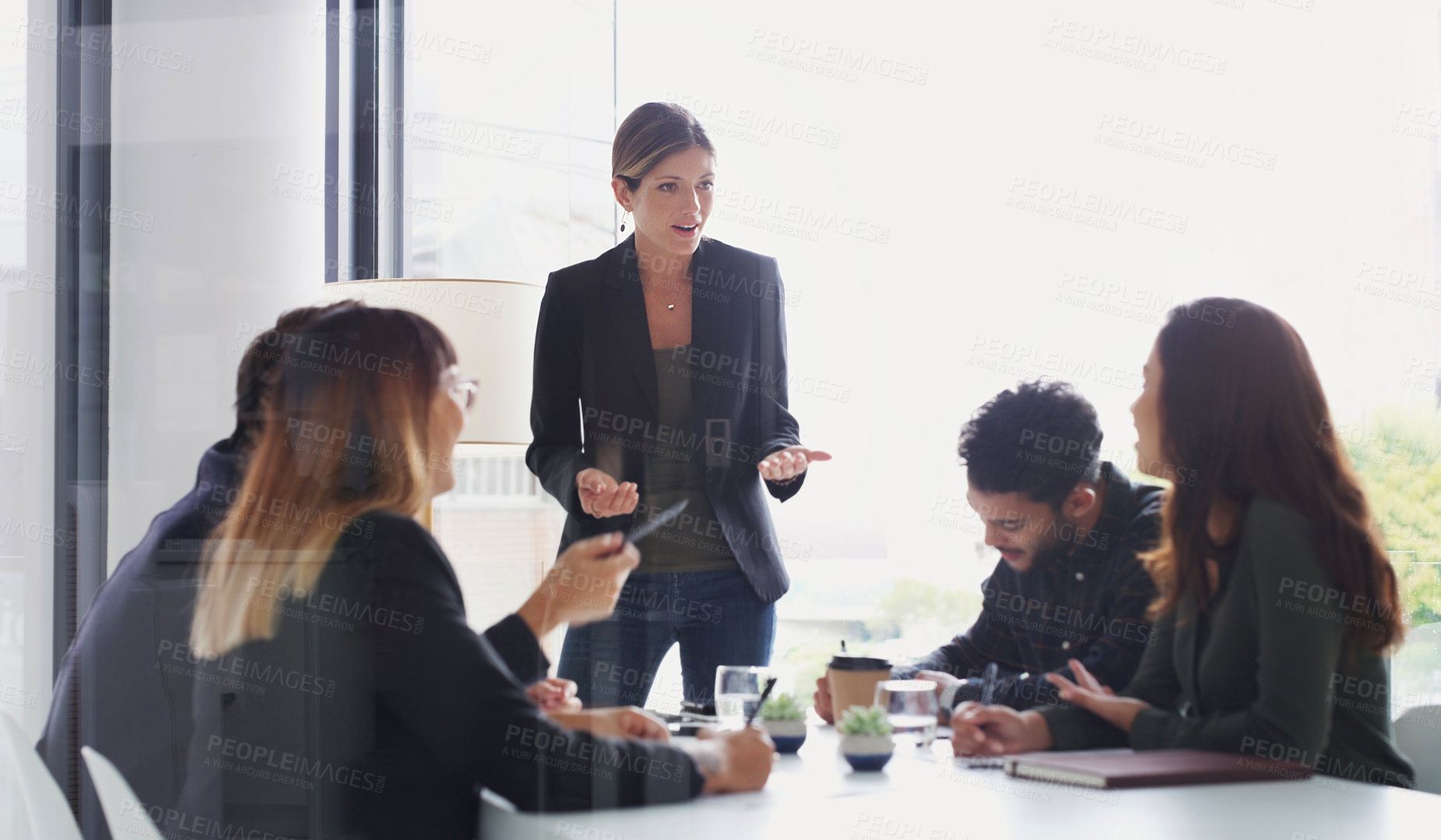 Buy stock photo Shot of a young businesswoman giving a presentation to her colleagues in an office