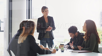 Buy stock photo Shot of a young businesswoman giving a presentation to her colleagues in an office