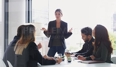 Buy stock photo Shot of a young businesswoman giving a presentation to her colleagues in an office