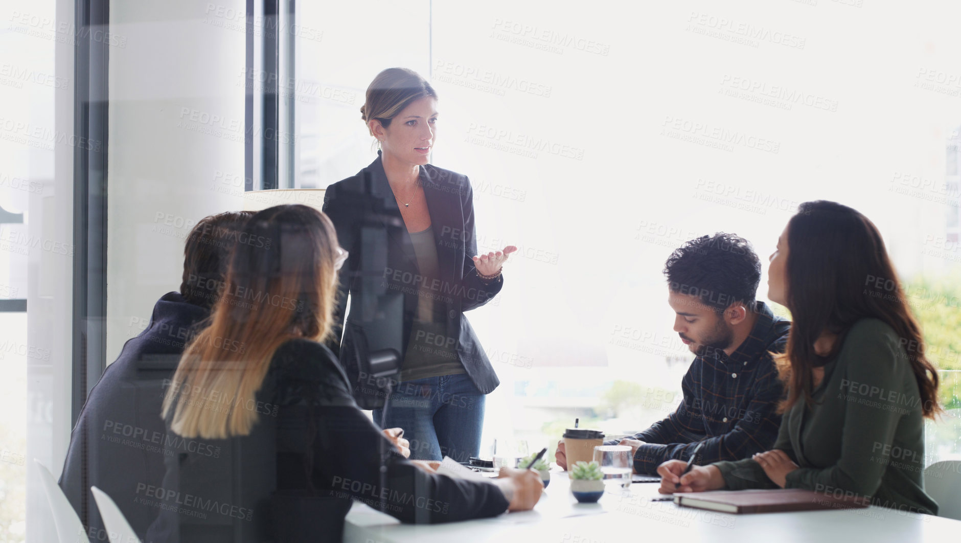 Buy stock photo Shot of a young businesswoman giving a presentation to her colleagues in an office