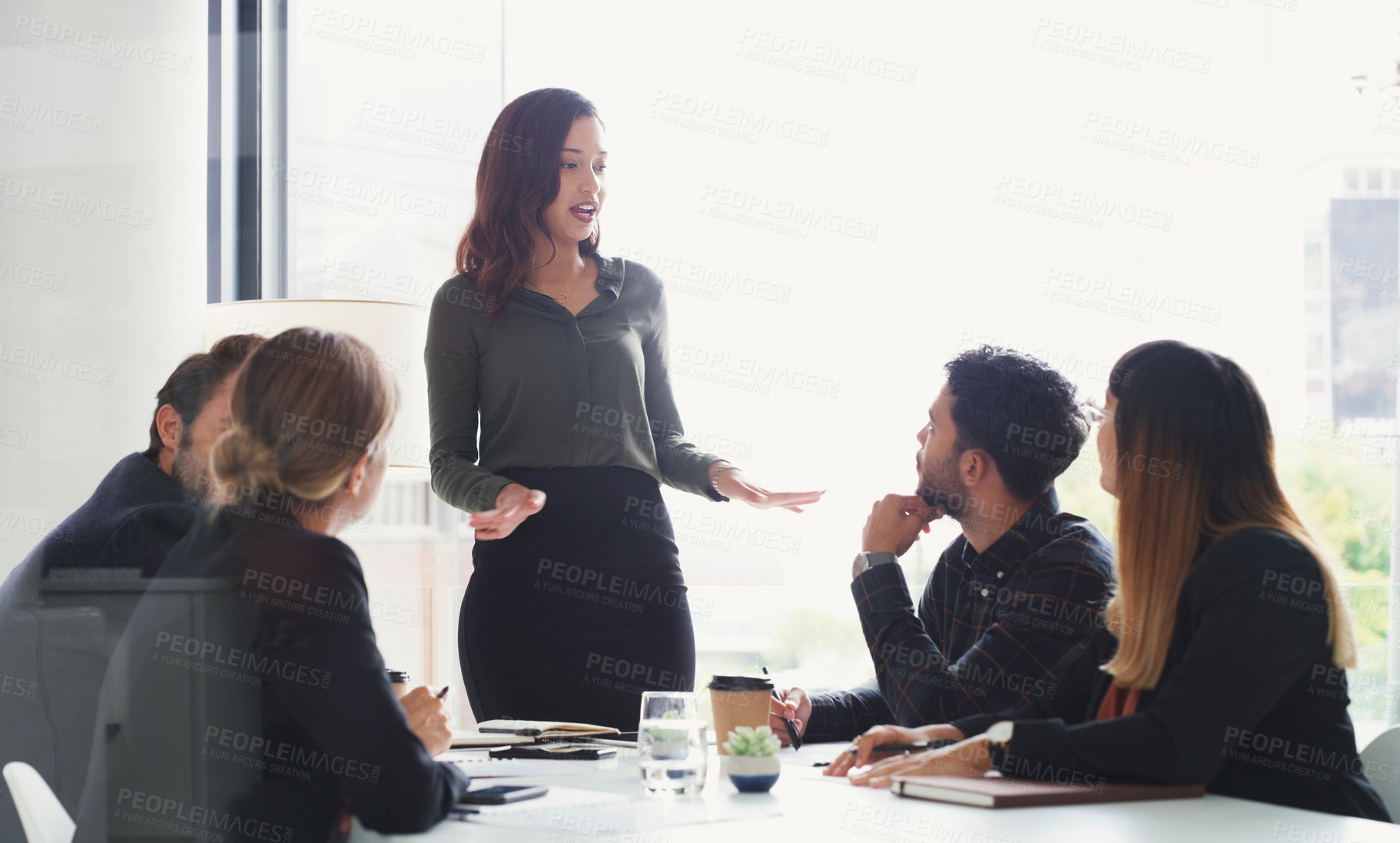 Buy stock photo Shot of a young businesswoman giving a presentation to her colleagues in an office