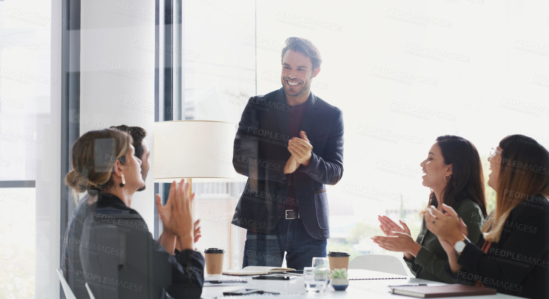 Buy stock photo Shot of a group of businesspeople applauding during a meeting in a boardroom