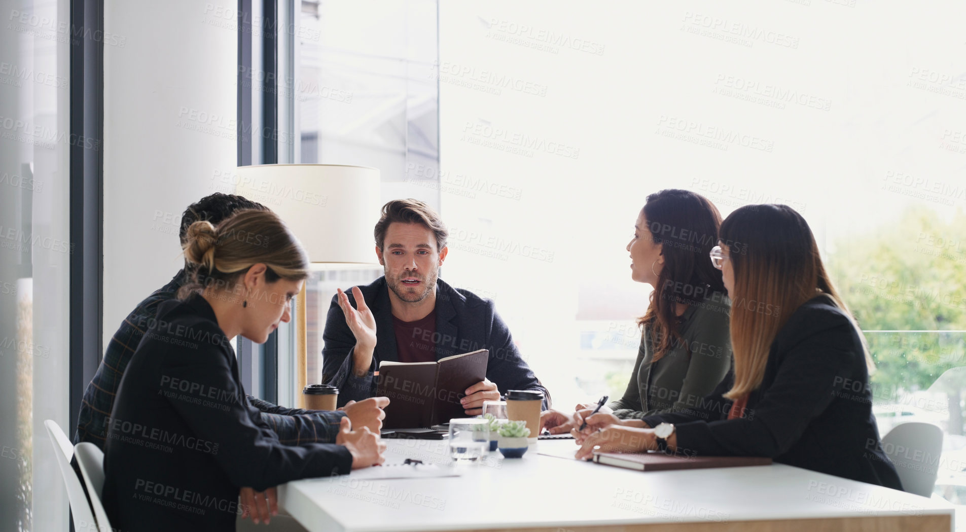 Buy stock photo Shot of a group of businesspeople having a meeting in a boardroom