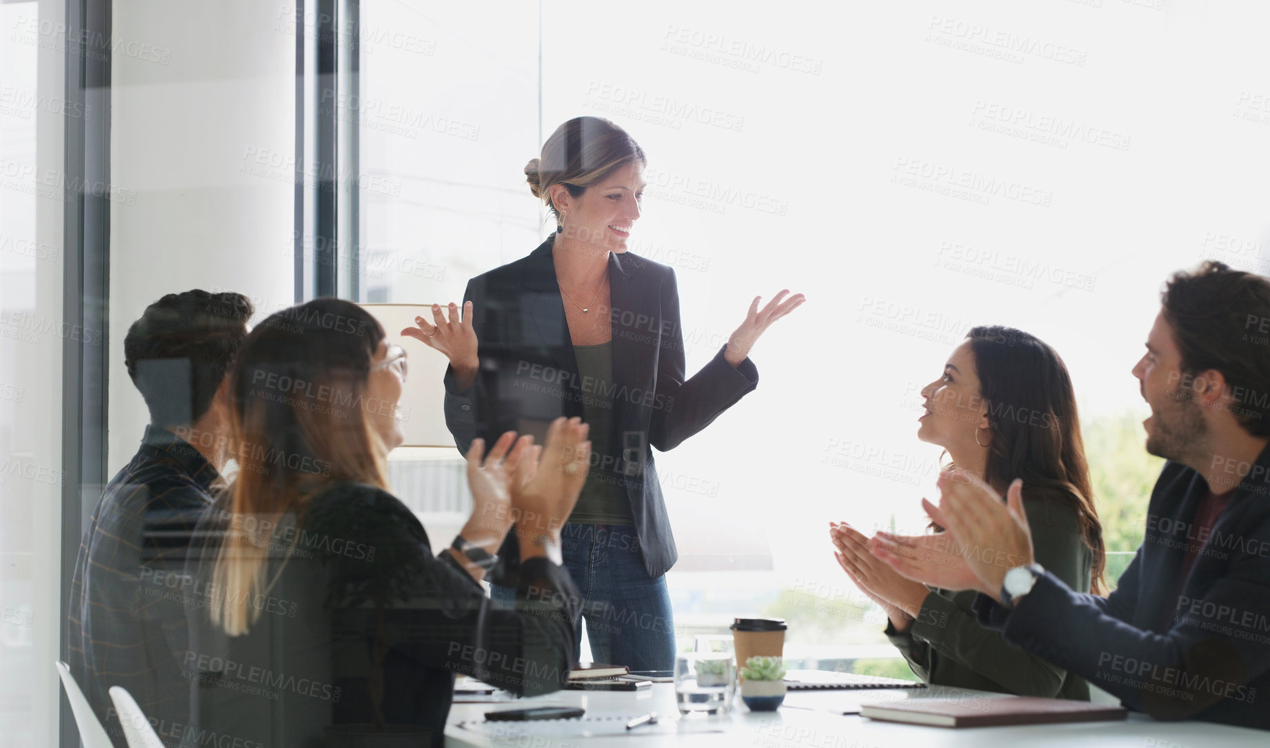 Buy stock photo Shot of a group of businesspeople applauding during a meeting in a boardroom