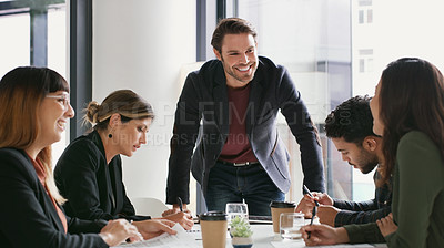 Buy stock photo Shot of a young businessman giving a presentation to his colleagues in an office