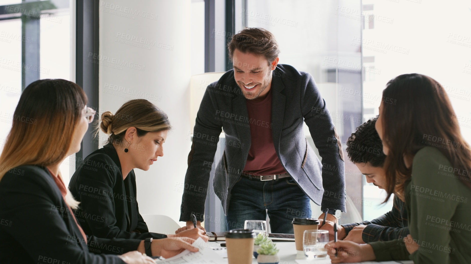 Buy stock photo Shot of a young businessman giving a presentation to his colleagues in an office