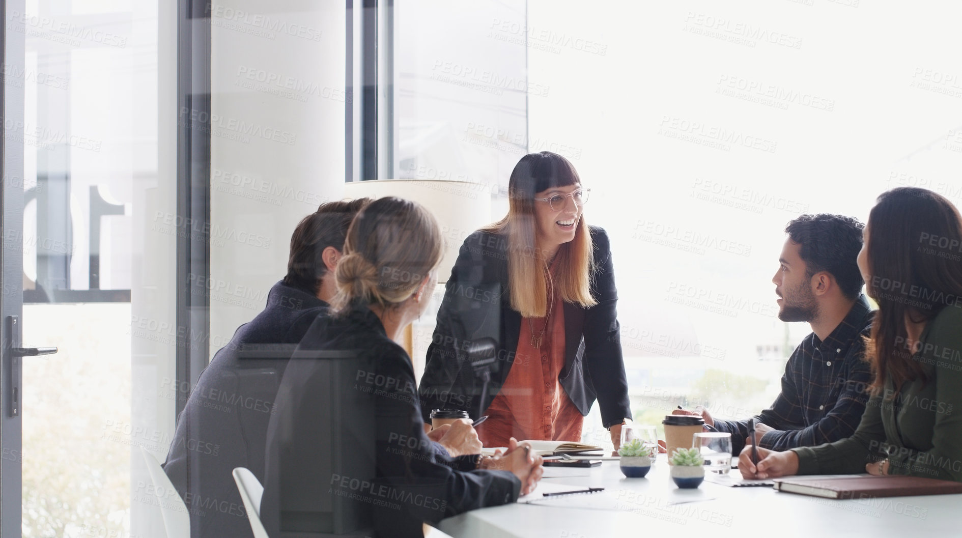 Buy stock photo Shot of a young businesswoman giving a presentation to her colleagues in an office