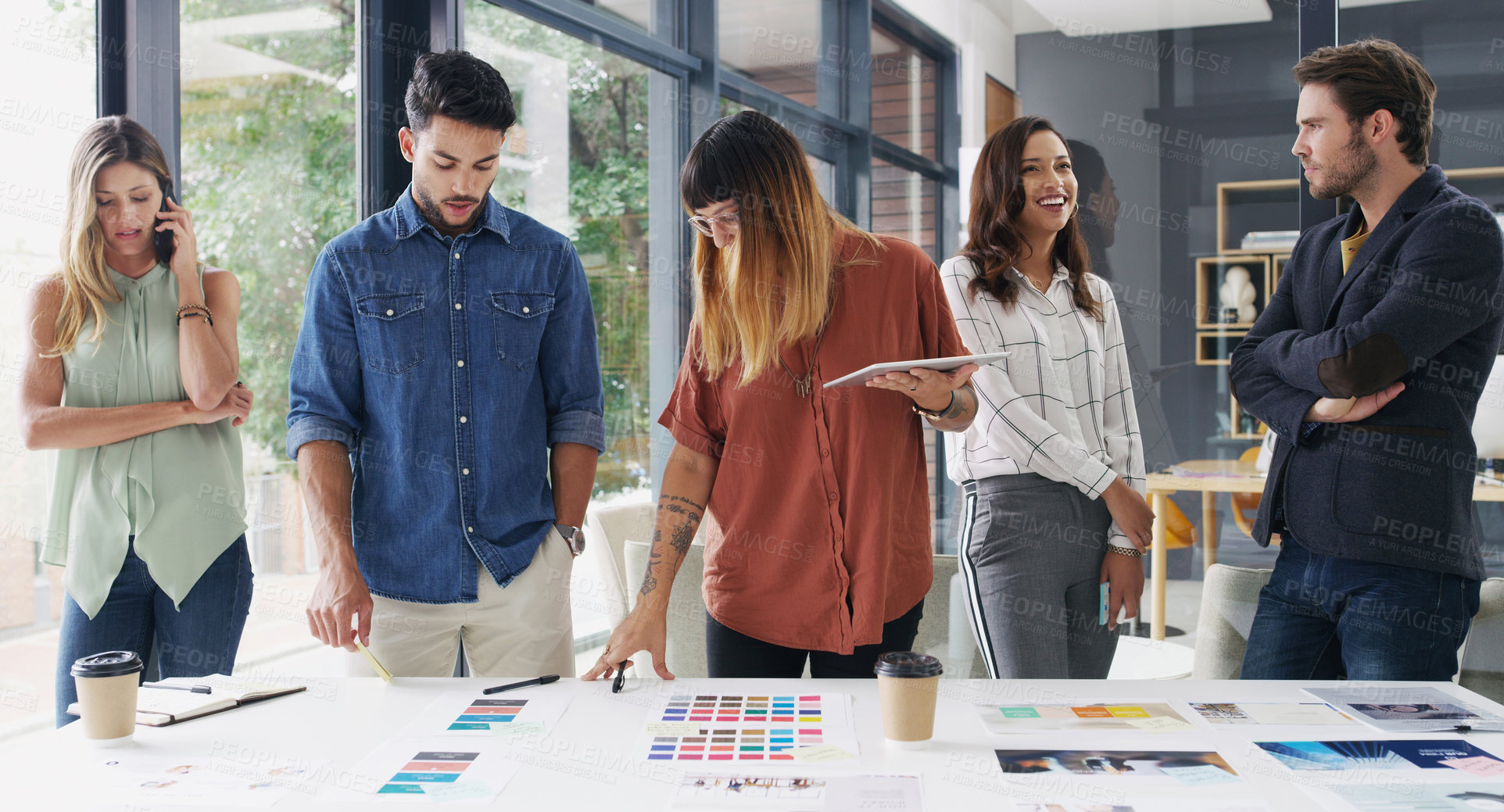 Buy stock photo Shot of a group of designers brainstorming together in an office