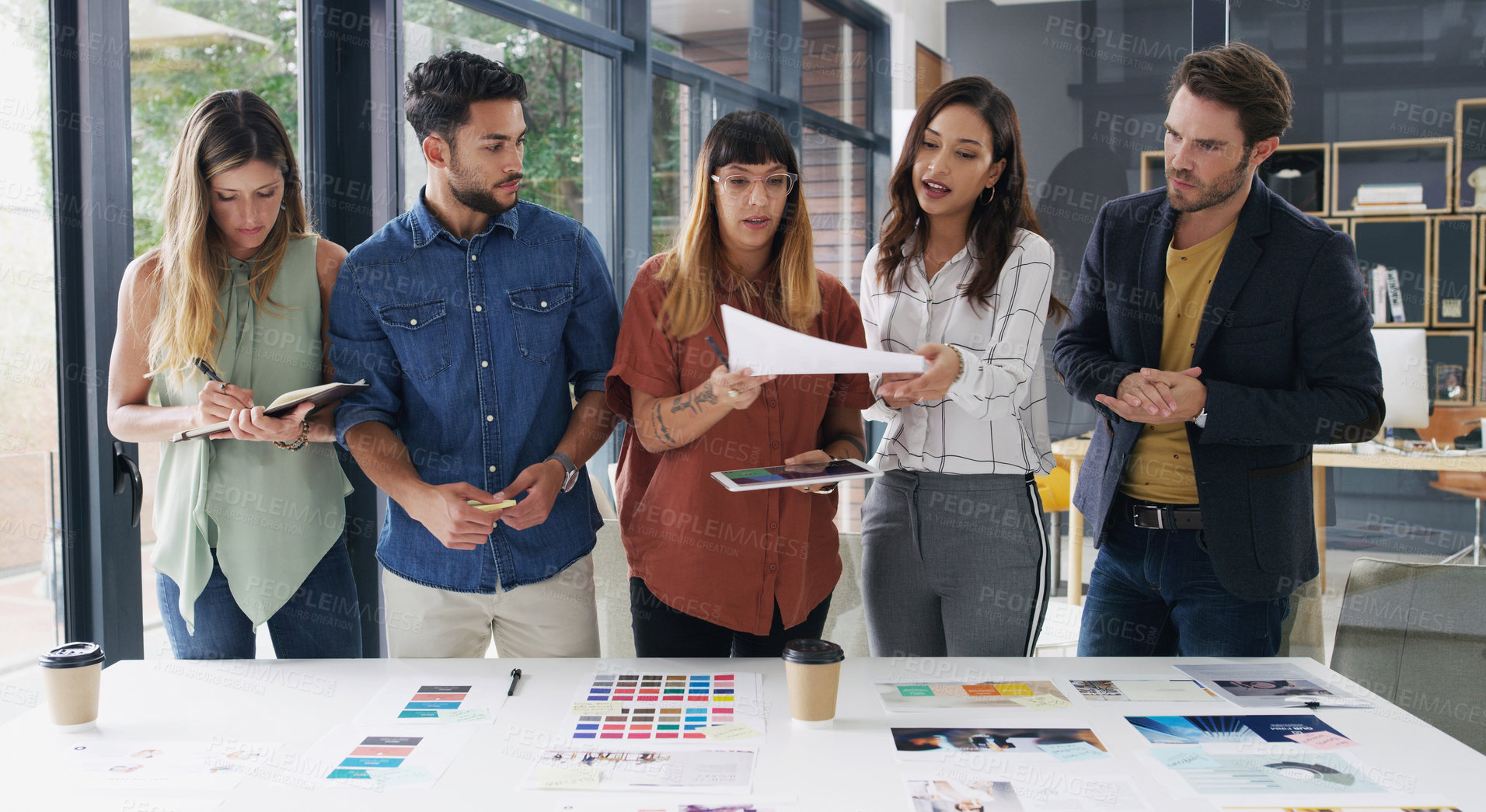Buy stock photo Shot of a group of designers brainstorming together in an office