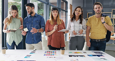 Buy stock photo Shot of a group of designers brainstorming together in an office