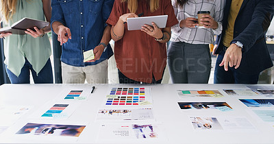 Buy stock photo Closeup shot of a group of designers going through paperwork together in an office