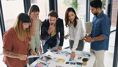 Buy stock photo Shot of a group of designers brainstorming together in an office