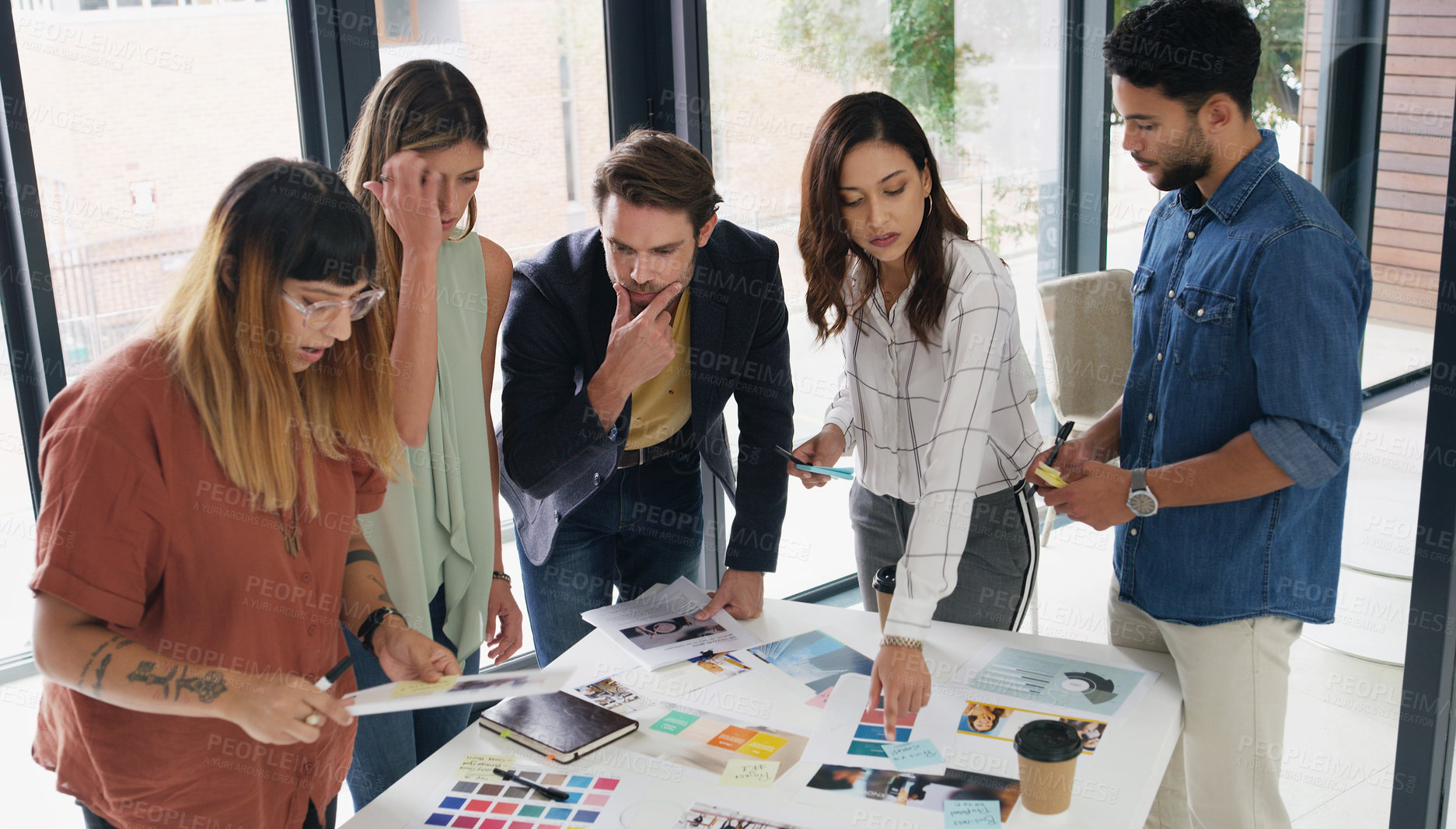 Buy stock photo Shot of a group of designers brainstorming together in an office