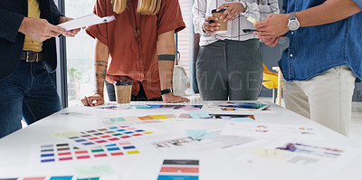 Buy stock photo Closeup shot of a group of designers going through paperwork together in an office