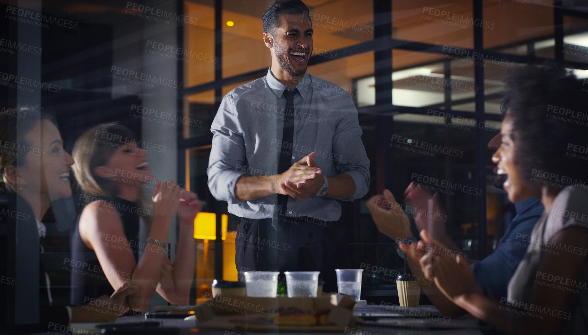 Buy stock photo Cropped shot of a diverse group of businesspeople clapping after a successful meeting in the office late at night