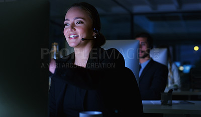 Buy stock photo Cropped shot of an attractive young businesswoman sitting in her office and wearing a headset while working on her computer