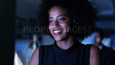 Buy stock photo Cropped shot of an attractive young businesswoman wearing a headset and sitting in the office late at night