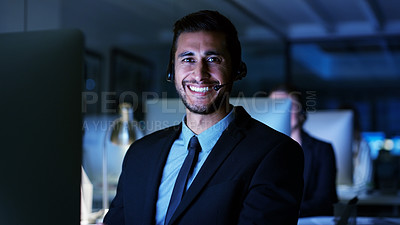 Buy stock photo Cropped portrait of a handsome young businessman sitting in his office and wearing a headset while working on his computer