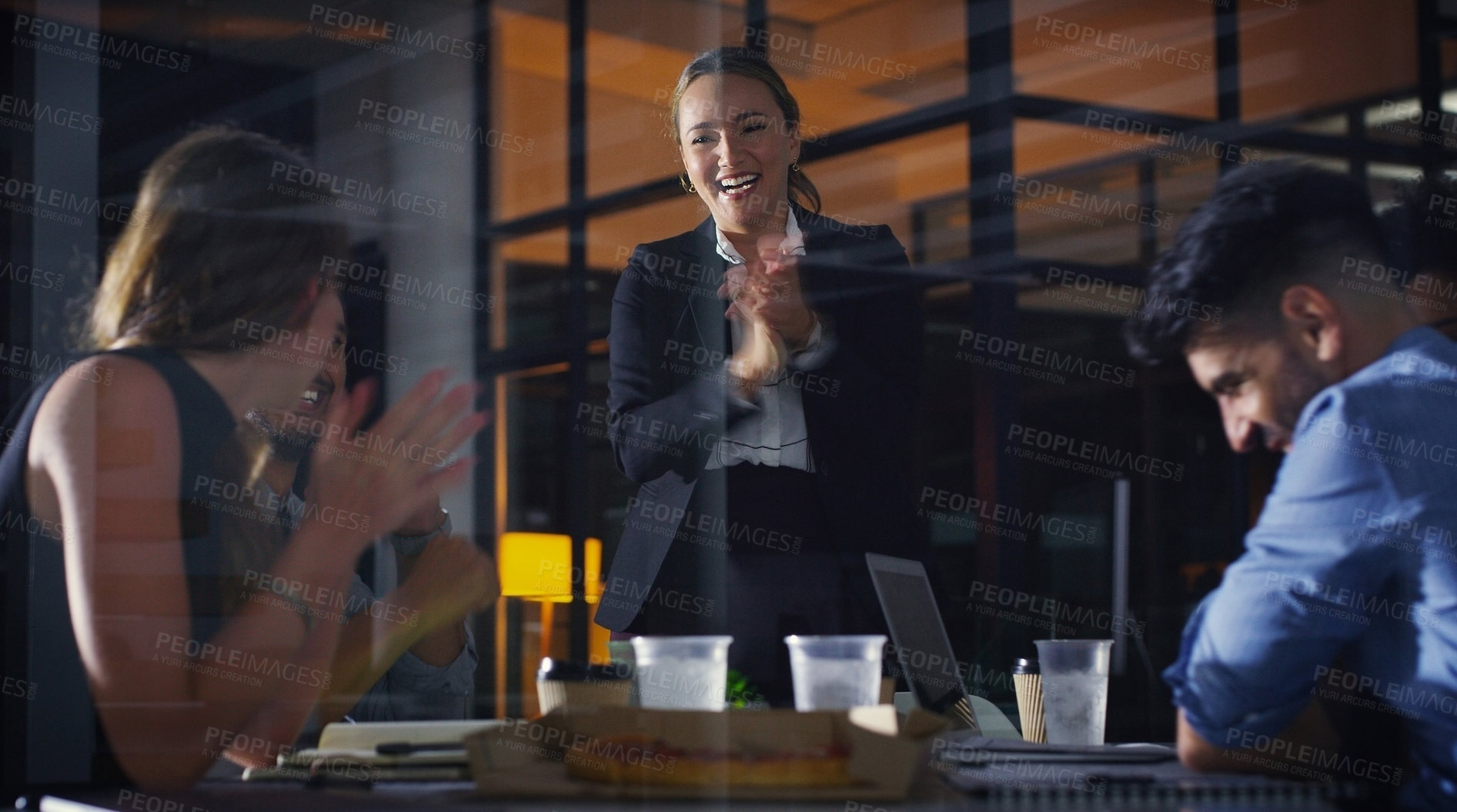 Buy stock photo Cropped shot of a diverse group of businesspeople clapping after a successful meeting in the office late at night