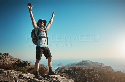 Buy stock photo Shot of an enthusiastic mature man hiking up a mountain