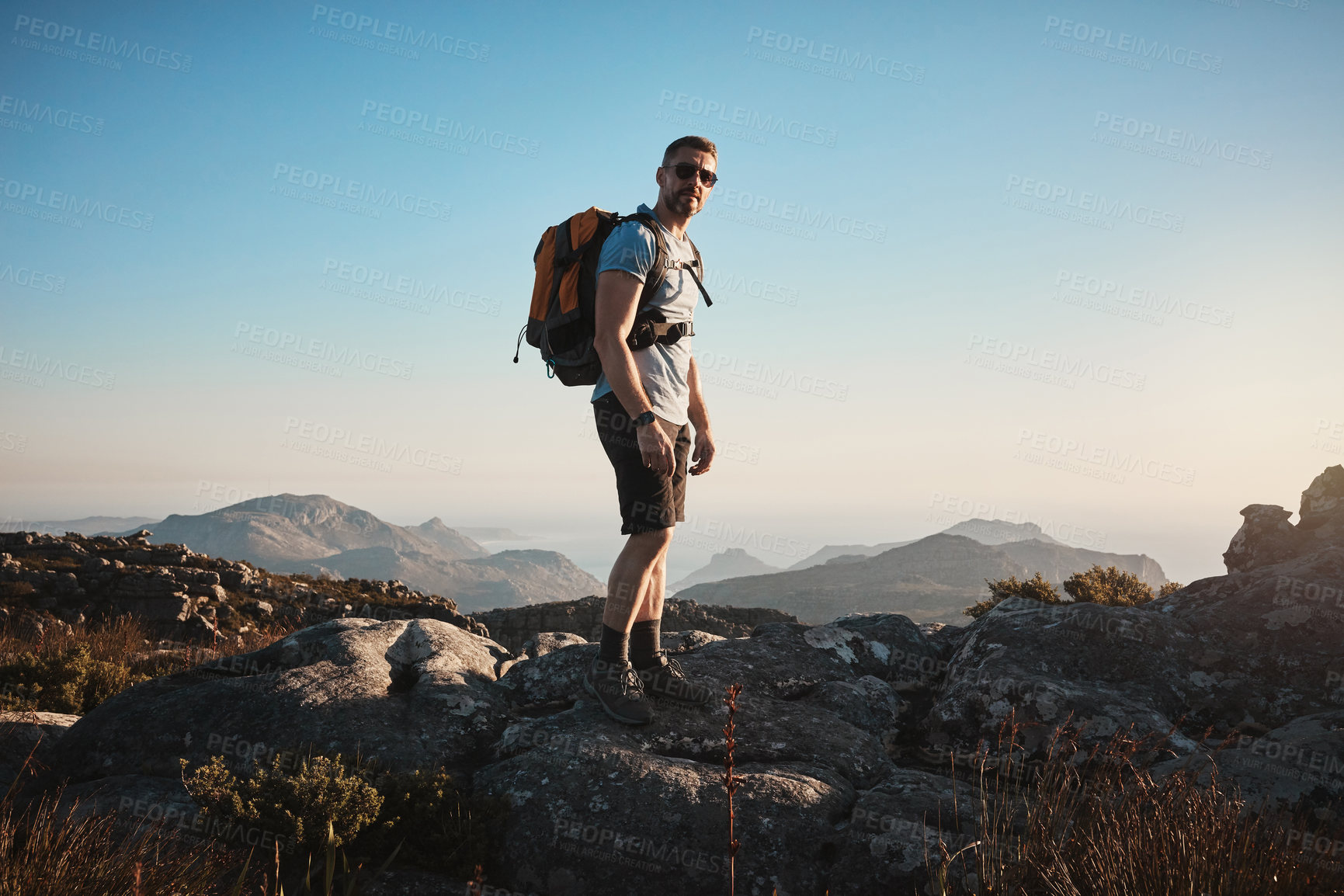 Buy stock photo Shot of a mature man hiking up a mountain