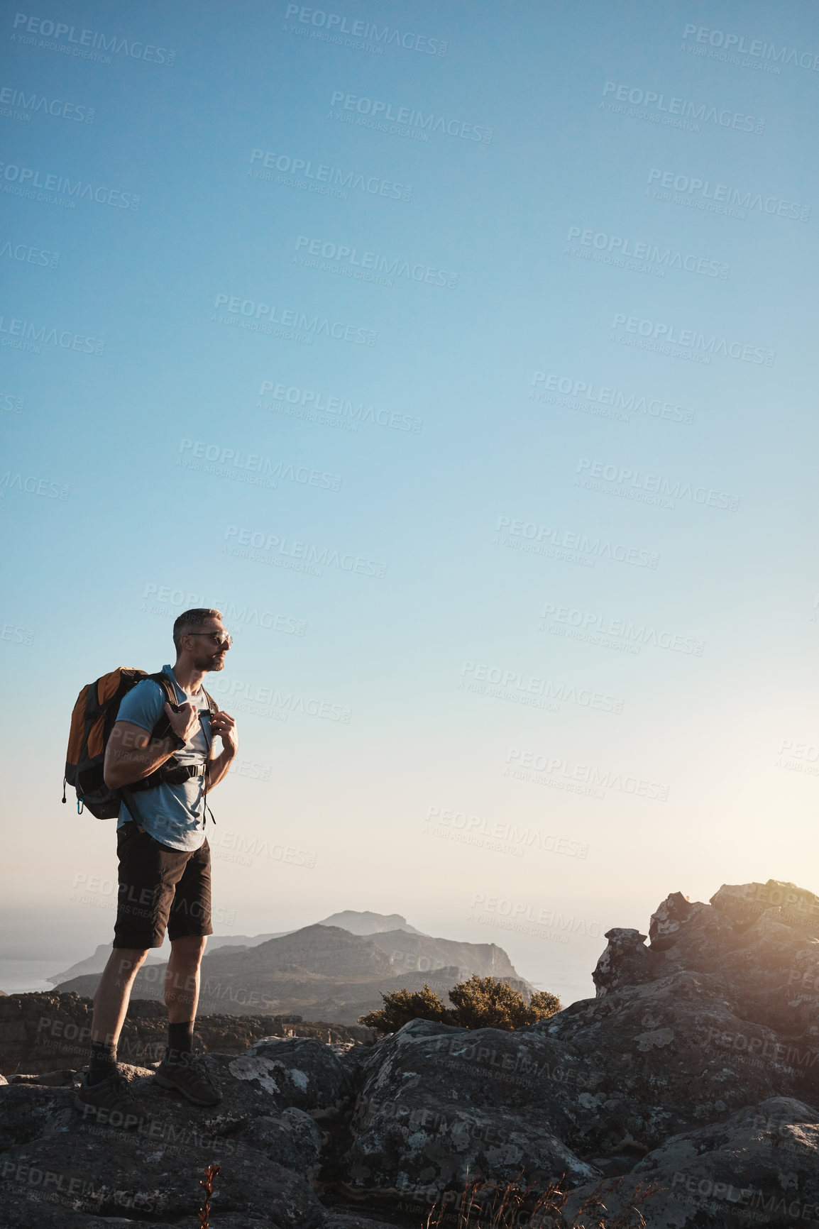 Buy stock photo Hiking, man and mountain on cliff outdoor for fitness travel, adventure view or mockup journey in summer. Male hiker, backpacking and trekking for cardio exercise, rock climbing and health wellness