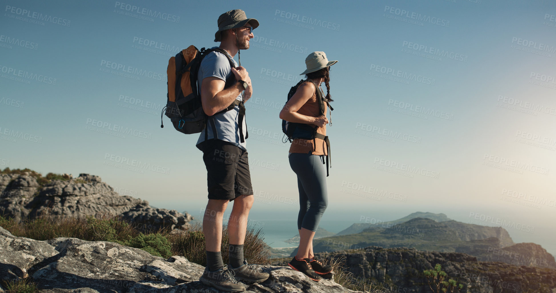 Buy stock photo Mountain, hiking and man with woman on peak for adventure in nature, landscape and travel. Outdoor trekking, couple on cliff and relax in scenic view for natural journey, walking and looking