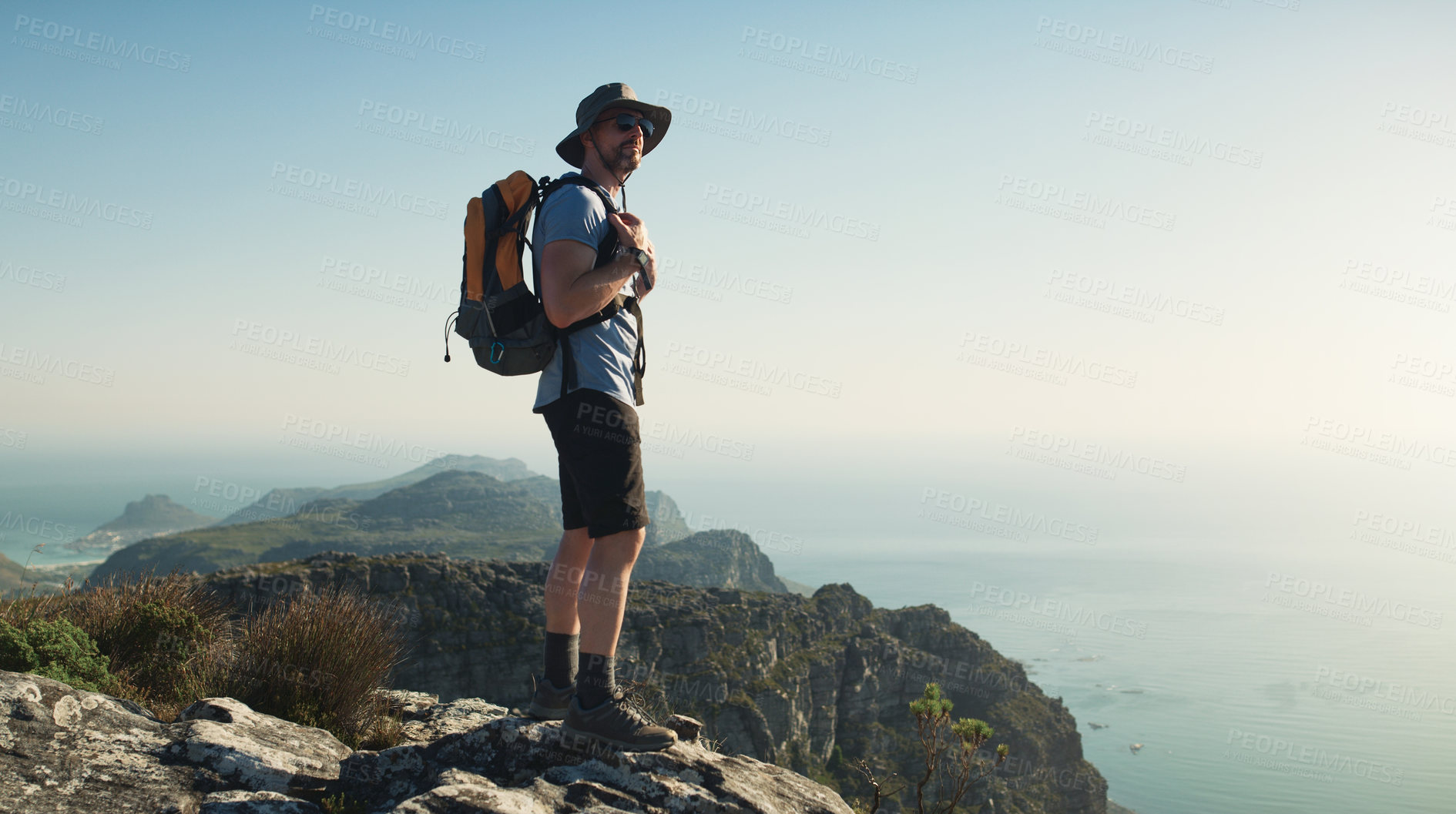Buy stock photo Shot of a mature man hiking up a mountain