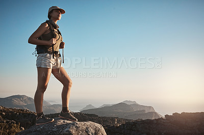 Buy stock photo Shot of a young woman hiking up a mountain