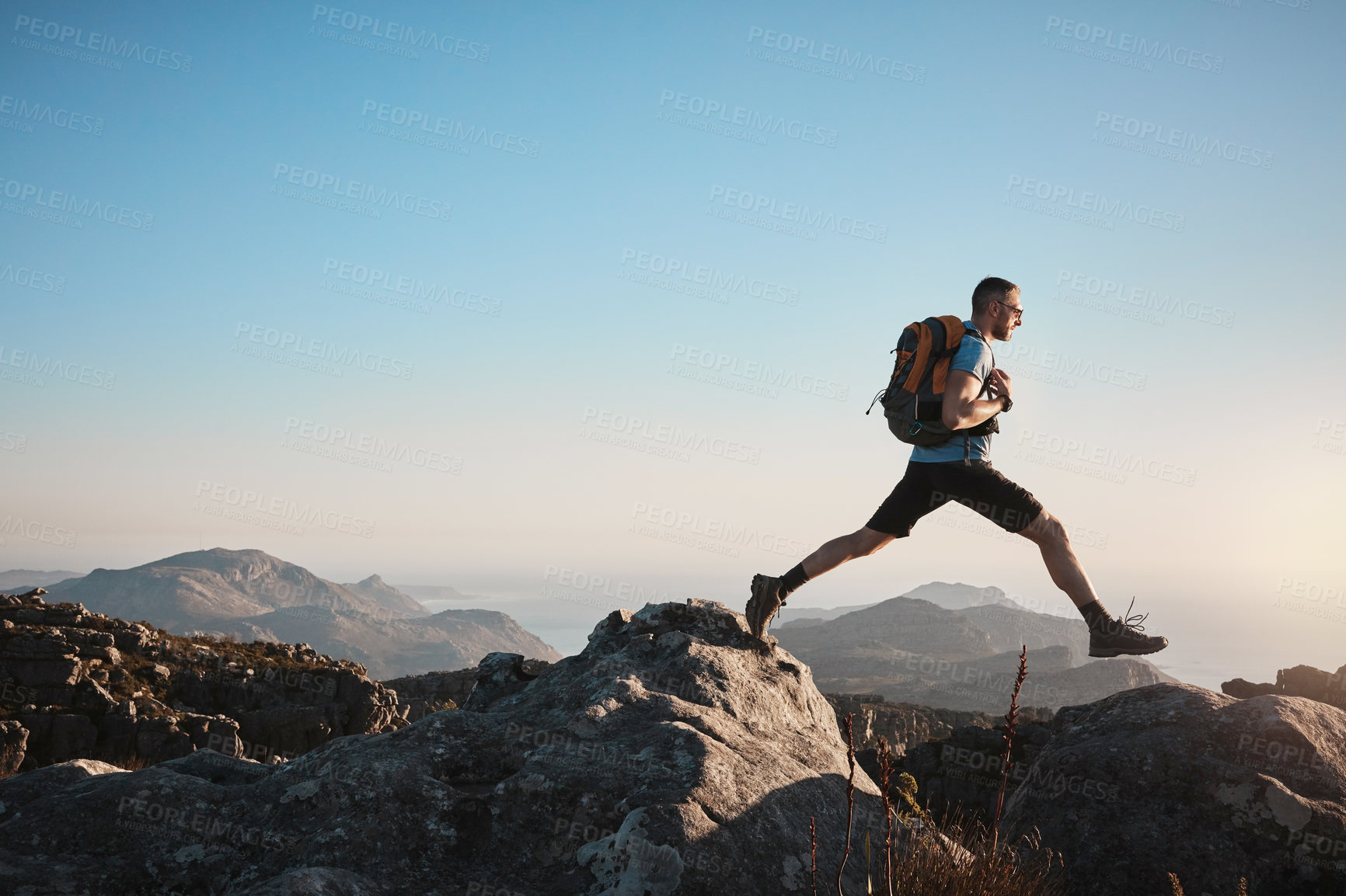 Buy stock photo Shot of a mature man hiking up a mountain