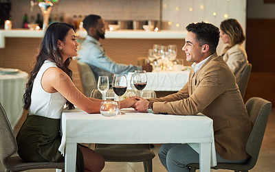 Buy stock photo Couple in restaurant for dinner, holding hands and romantic date on Valentines day, love and celebrate holiday. Commitment, interracial relationship and man with woman, trust, support and celebration