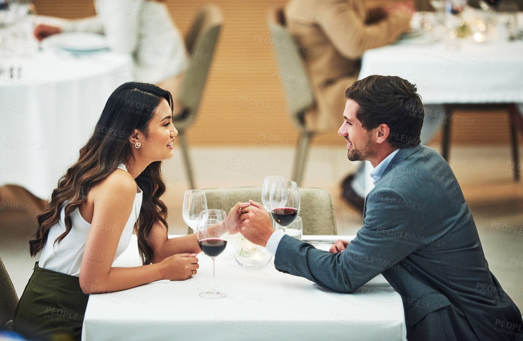 Buy stock photo Restaurant, date and couple holding hands with wine for romantic dinner, relax and anniversary celebration. Relationship, fine dining and man and woman enjoying luxury drinks, alcohol and valentines