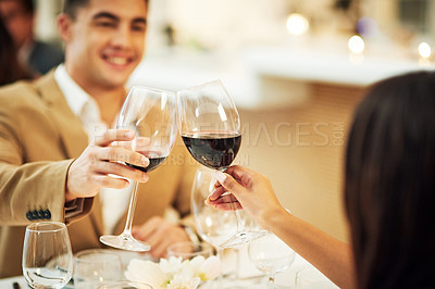 Buy stock photo Toast, wine and couple in restaurant for celebration, romantic dinner and anniversary together. Relationship, fine dining and man and woman cheers with drinks, alcohol and relax at hotel on honeymoon
