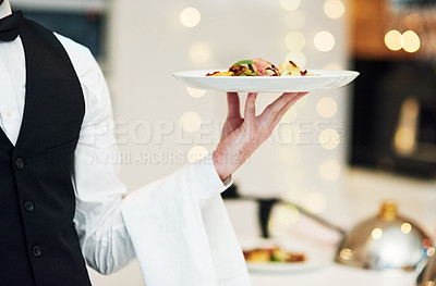 Buy stock photo Fine dining, food and waiter serving at a restaurant for a luxury valentines day or anniversary meal. Formal, hospitality service and server with a plate or dish for a fancy special dinner date.