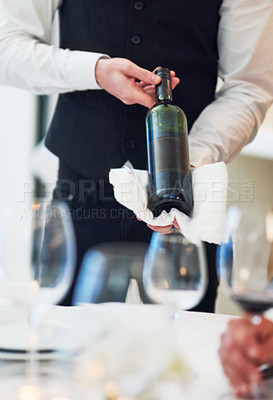 Buy stock photo Waiter hands, wine and restaurant table with white towel, luxury hospitality and vintage for fine dining. Man, bottle service and holding drink for customer decision at celebration on valentines day