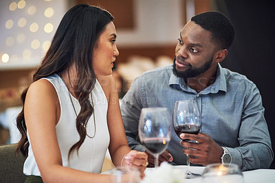 Buy stock photo Love, conversation and couple on a date at a restaurant for valentines day, romance or anniversary. Wine, communication and interracial man and woman talking at luxury romantic dinner event together.