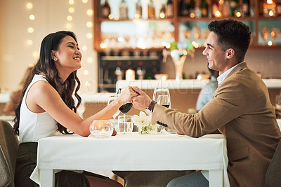 Buy stock photo Happy couple holding hands, restaurant and dinner date on Valentines day, celebrate holiday with love, care and romance. Commitment, interracial relationship and man with woman, trust and support