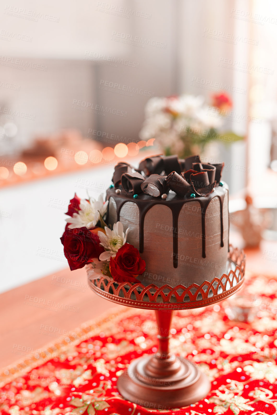 Buy stock photo Chocolate cake, red and roses for wedding reception on pedestal for celebration, social event and dessert. Luxury, cocoa and frosting with flowers for decoration, sweet and confectionary for party