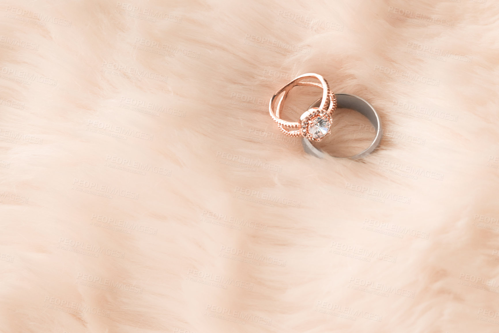 Buy stock photo Shot of two wedding rings on a furry background