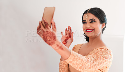 Buy stock photo Shot of a young woman waving while using a smartphone on her wedding day