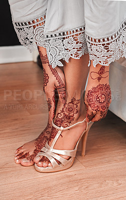 Buy stock photo Cropped shot of an unrecognizable woman putting on shoes in preparation for her wedding