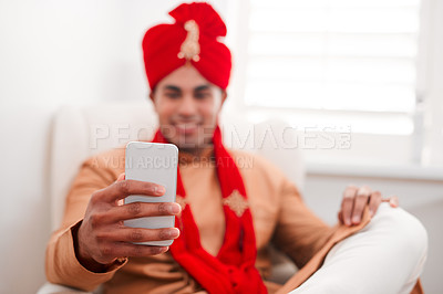 Buy stock photo Shot of a young man using a smartphone on his wedding day